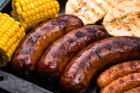 Grilled sausages, meat, and vegetables.の写真素材