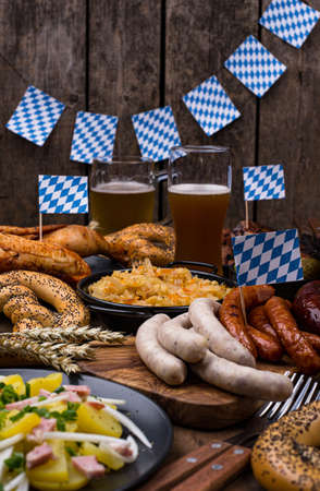 Oktoberfest dishes with beer, pretzel and sausageの写真素材