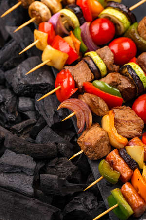 Grilled kebabs with meat, mushrooms and vegetablesの写真素材
