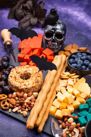 Cheese plate with berries, grapes and snacksの写真素材