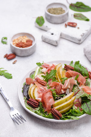 Salad with pear, prosciutto and nutsの写真素材