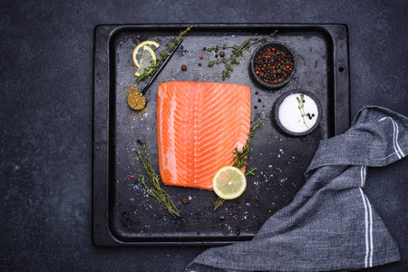 Raw salmon fillet with herbsの写真素材