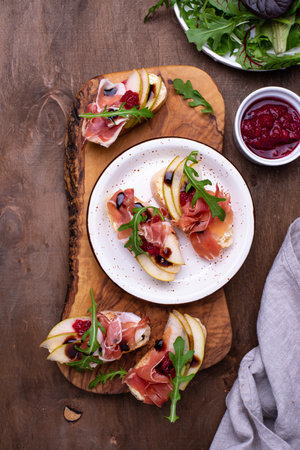 Toasts with pear and prosciuttoの写真素材