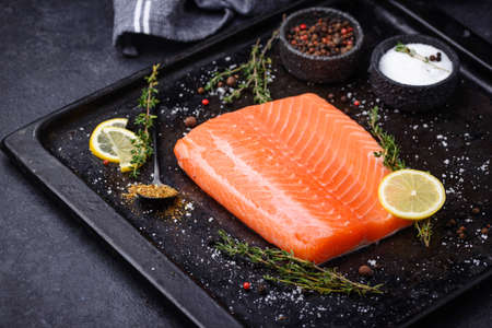 Raw salmon fillet with herbsの写真素材