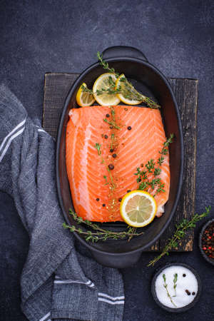 Raw salmon fillet with herbsの写真素材