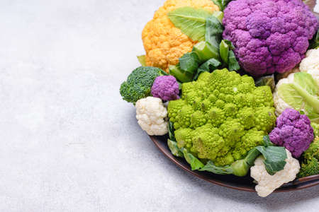 Purple, yellow, white and green color cauliflowersの写真素材