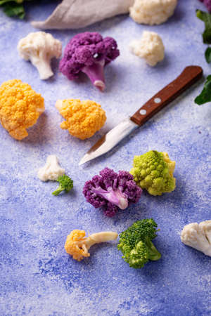 Purple, yellow, white and green color cauliflowersの写真素材