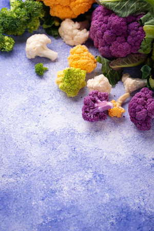 Purple, yellow, white and green color cauliflowersの写真素材