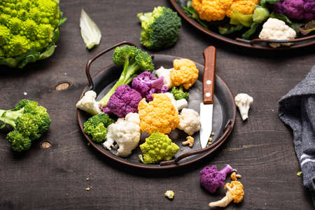 Purple, yellow, white and green color cauliflowersの写真素材