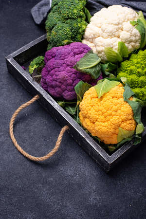 Purple, yellow, white and green color cauliflowersの写真素材