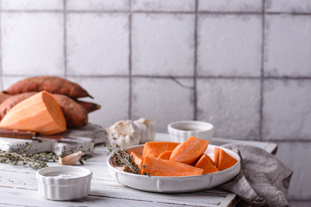 Raw sweet potato with herbs and garlicの写真素材