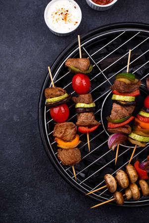 Grilled kebabs with meat, mushrooms and vegetablesの写真素材