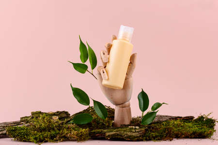 Cosmetic tube mockup on wooden handの写真素材