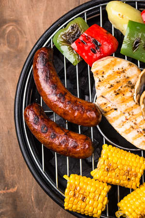 Grilled sausages, meat, and vegetables.の写真素材