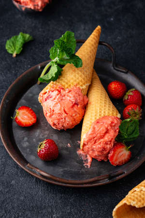 Strawberry ice cream in waffle coneの写真素材