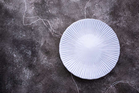 Plate on grey concrete backgroundの写真素材