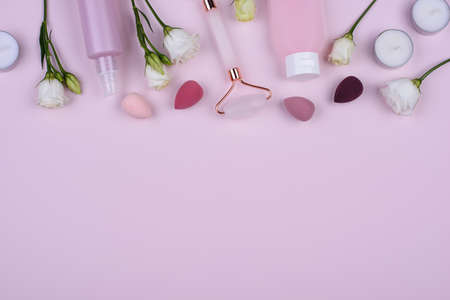 Rose quartz roller and cosmetic tubesの写真素材