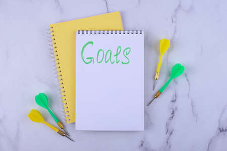 Target and goal concept with arrows and notebookの写真素材