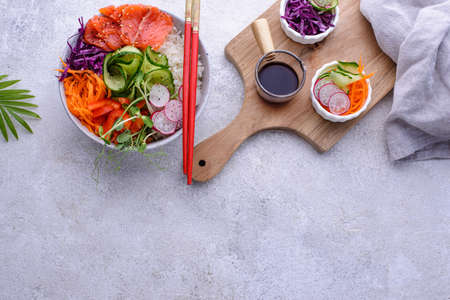Hawaiian poke bowl with salmon, rice and vegetablesの写真素材
