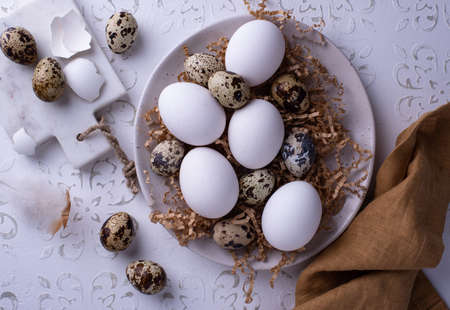 Bowl with chicken and quail raw eggs oの写真素材