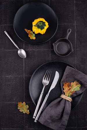 Autumn table setting on dark tile backgroundの写真素材