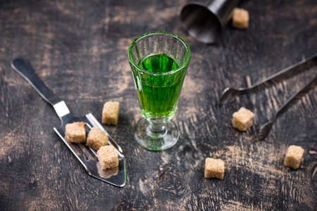 Glass of absinthe with cane sugarの写真素材