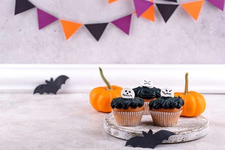 Scary Halloween cupcakes with spooky decorationの写真素材