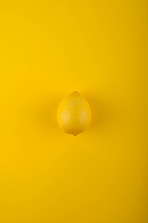 Ripe lemon on yellow background.の写真素材