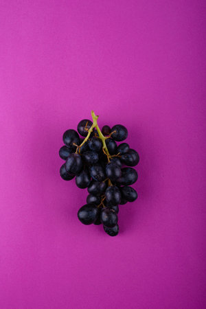 Red grape on purple violet background. Harvest concept