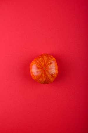 Red fresh ripe tomato on red backgroundの写真素材