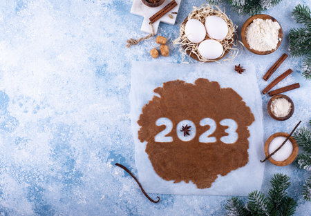 Gingerbread dough for cookies in shape of 2023の写真素材