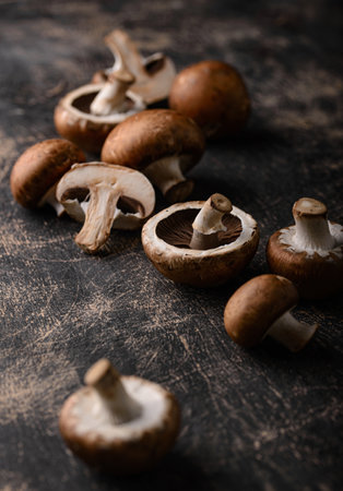 Raw champignon mushrooms on black backgroundの写真素材