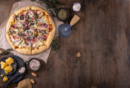 Italian pizza carbonara with bacon and herbsの写真素材