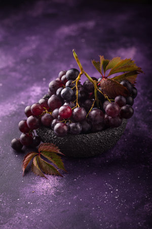 Purple grapes on violet backgroundの写真素材