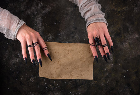 Witch hand and empty paper, space for textの写真素材