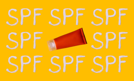 Sunscreen SPF sunblock cream on yellow background