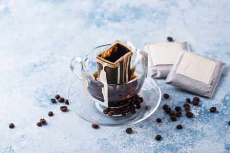 Freshly brewed drip coffee in glass cupの写真素材