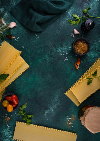 Uncooked lasagna pasta with cooking ingredientの写真素材