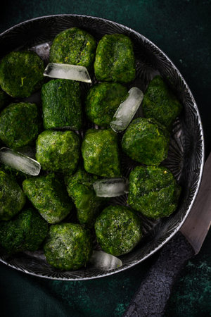 Frozen spinach green cubes in bowl