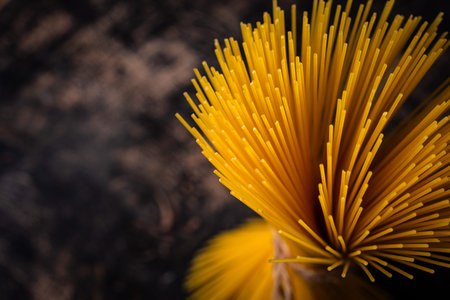 Raw uncooked sspaghetti on dark backgroundの写真素材