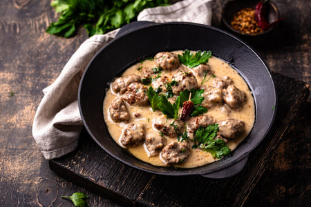 Meatballs in sour cream sauce in a frying panの写真素材