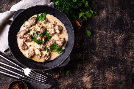 Meatballs in sour cream sauce in a frying panの写真素材