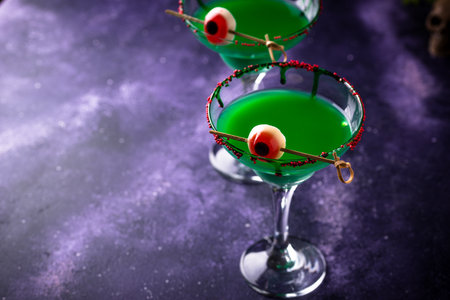 Spooky green halloween cocktail with eyeballsの写真素材