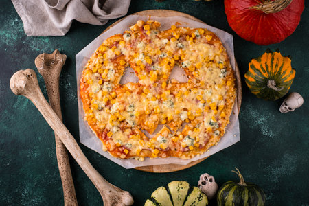 Halloween scary pizza in shape of pumpkinの写真素材