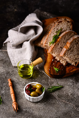 Fresh bread, olive oil and mix of olives.の写真素材