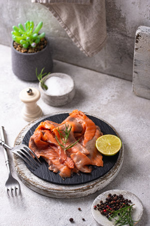 Salted sliced salmon fish with herbsの写真素材