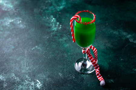 Christmas green cocktail punch with candy caneの写真素材