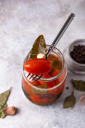 Marinated pickled tomatoes in jarの写真素材