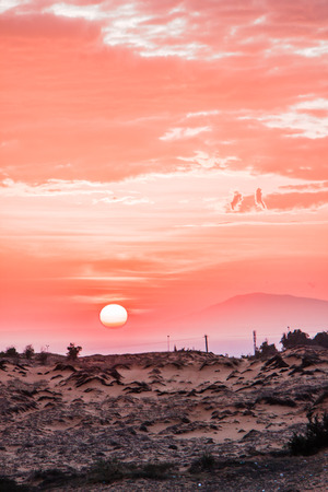 sunset in the desert. red dunes, Vietnam.の写真素材