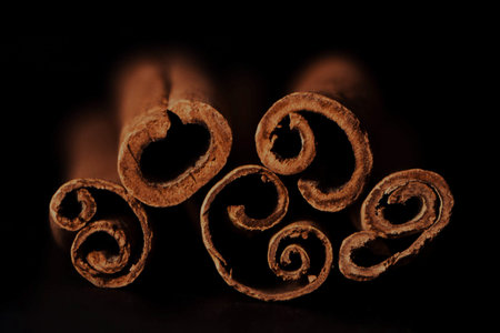 Cinnamon sticks on black background close up